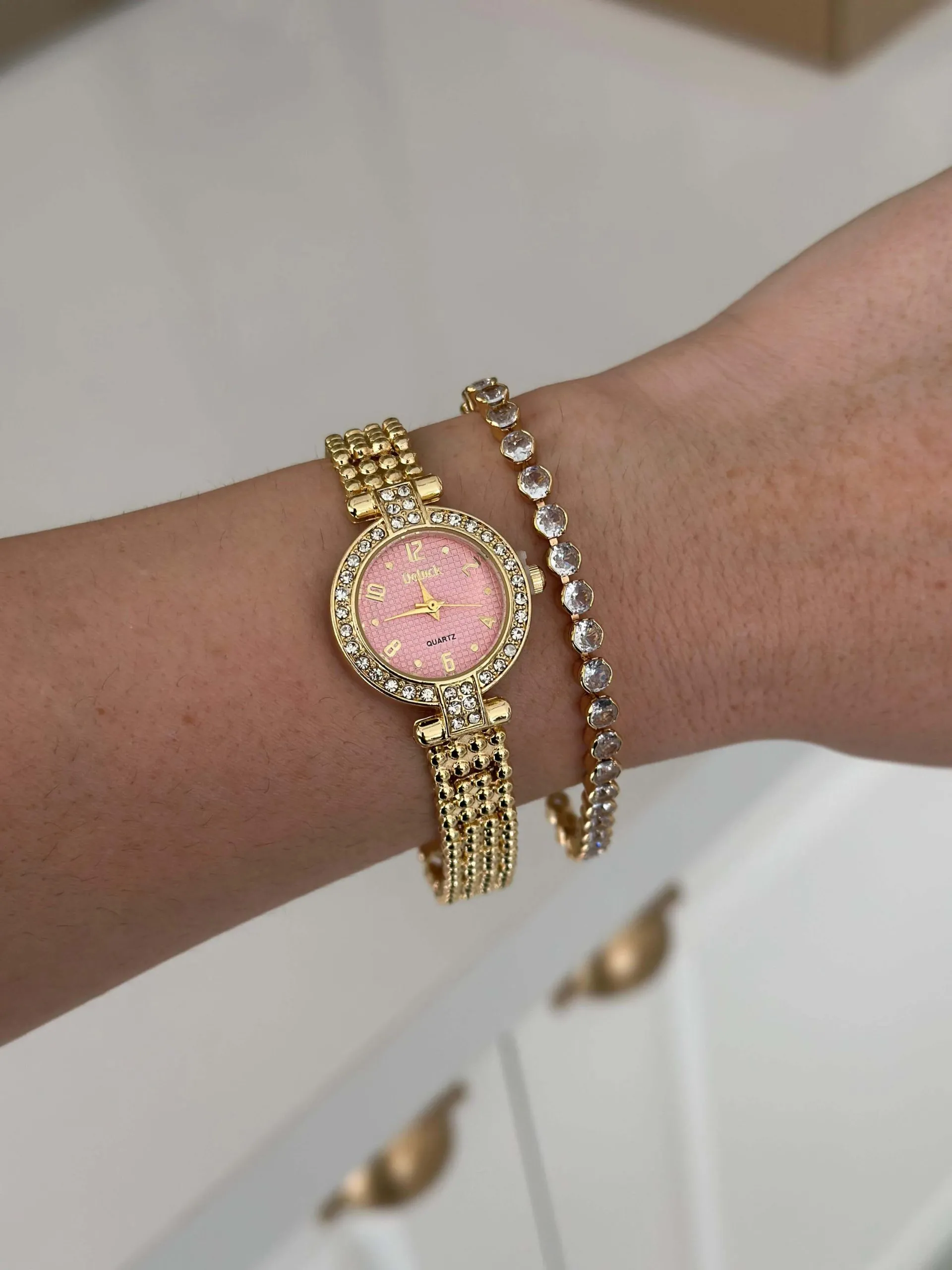 Relógio Dourado Oval Cravejado com Fundo Rosa